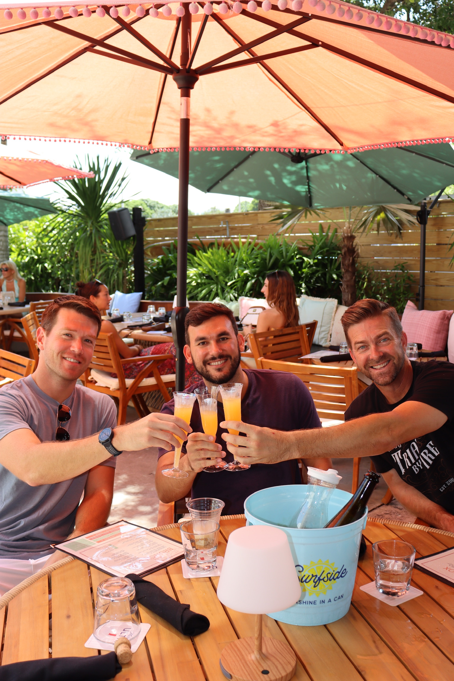 Guests toasting with mimosas on the patio at The Standard Delray Beach
